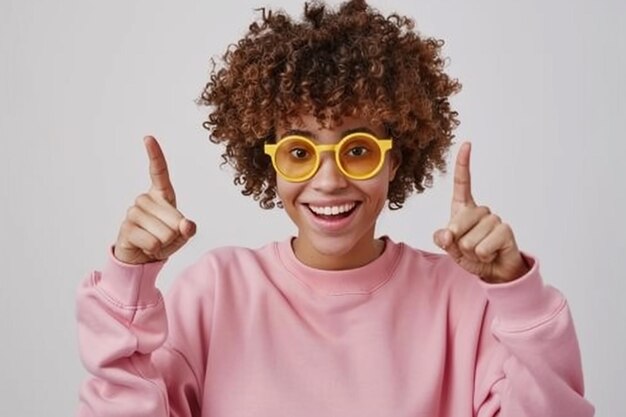 Фото Стильная молодая женщина в розовом капюшоне и желтых солнцезащитных очках