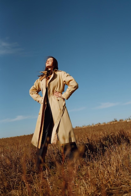 Stylish young woman posing in a field Fashion glamour lifestyle concept Autumn