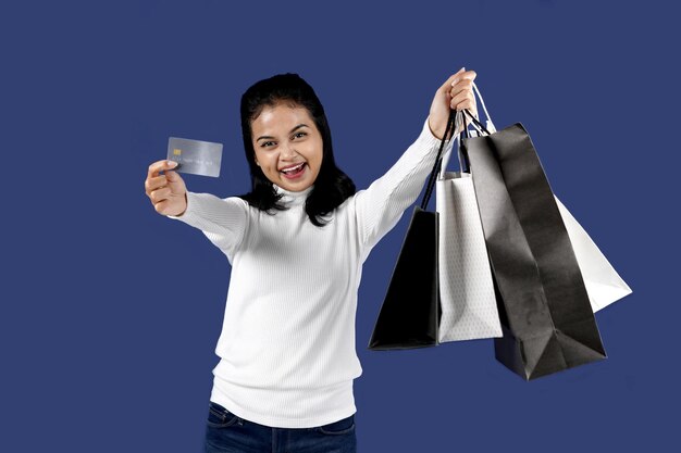 Stylish young woman posing happily with shopping bags