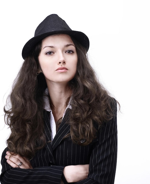 Stylish young woman in suit and hat