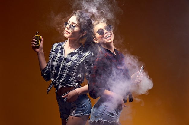 Stylish young woman in sunglasses smoking