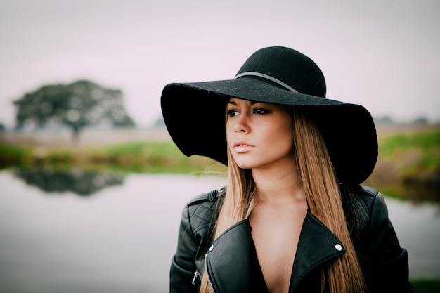 Stylish young woman with beautiful hat 