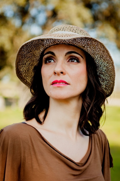 Stylish young woman with straw hat 