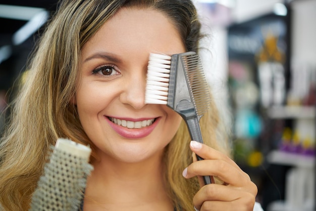 Stylist showing hair dyeing brush