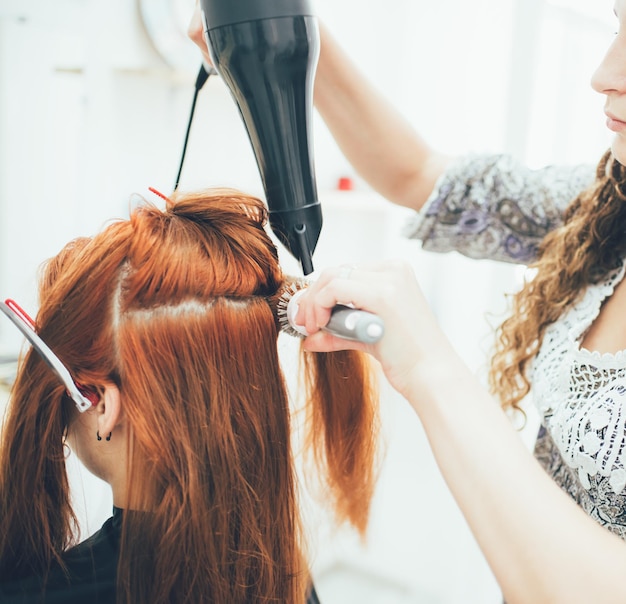 Stylist working in the beauty salon haircut and hair styling