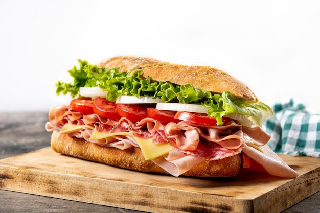 Submarine sandwich with ham cheese lettuce tomatoesonion mortadella and sausage