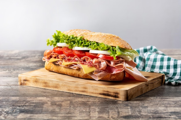 Submarine sandwich with ham cheese lettuce tomatoesonion mortadella and sausage