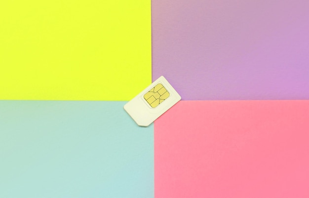 Subscriber identity module white sim card on pastel background