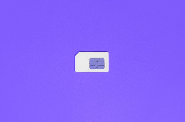 Subscriber identity module. White SIM card on violet