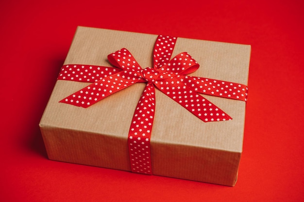Подписные коробки для подарения и получения Подписные подарочные коробки Уход за пакетом с красной лентой на красном фоне