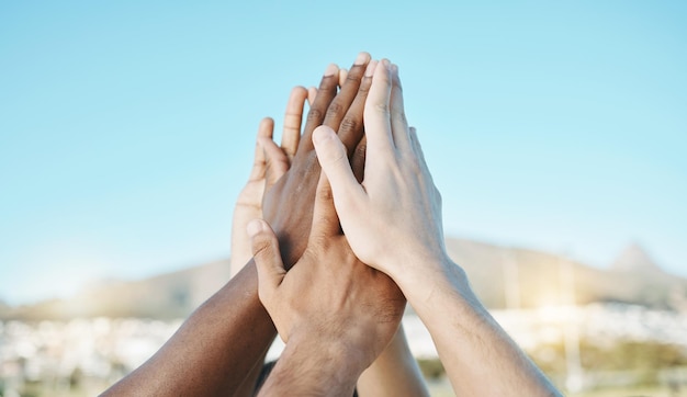 Succes high five of handen van team op veld klaar voor training of sportwedstrijd buitenshuis Fitnessinspiratie of mensen met motivatie op voetbalveld samen ter ondersteuning of solidariteit