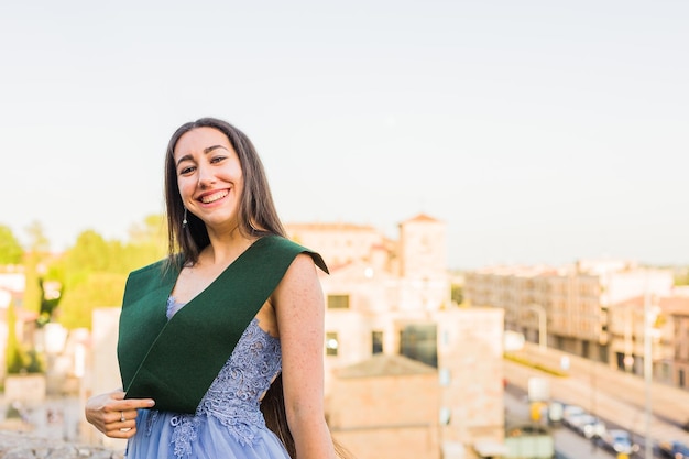 Success and achievement bachelor degree Happiness portrait in Salamanca Campus with long dress and graduation stole One person in Europe Spain