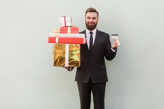 Success businessman toothy smile holding box and credit card