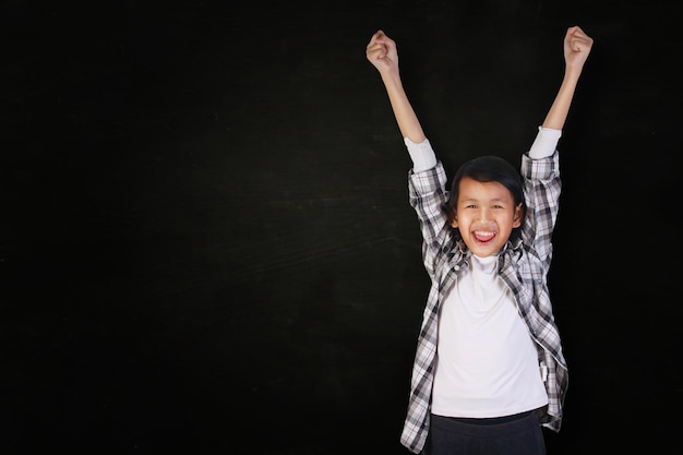 Success concept portrait of happy and smiling cute beautiful Asian girl showing winning gesture