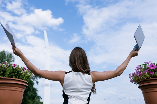 Photo success in e-commerce. internet business. successful woman took vacation, blue sky background