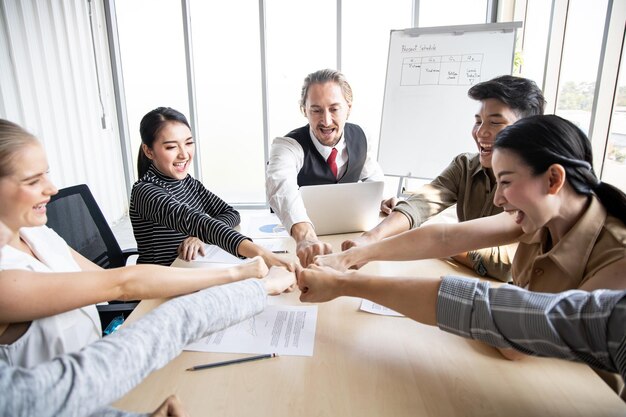 Success of group business people with join hands of teamwork in meeting room. Hands coming together of team. Teamwork success concept.