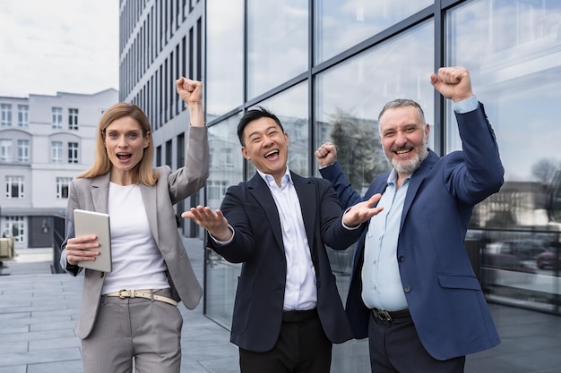 Success happy group business people excited rejoicing looking at camera after successful completion