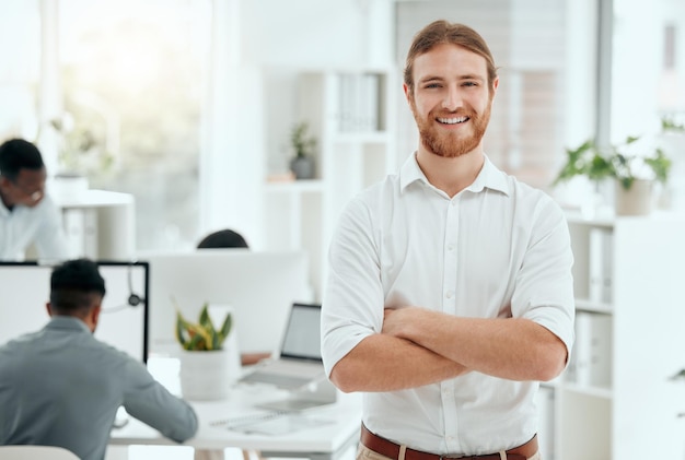 Success is there for those who work for it Cropped portrait of a handsome young businessman standing with his arms folded in the office