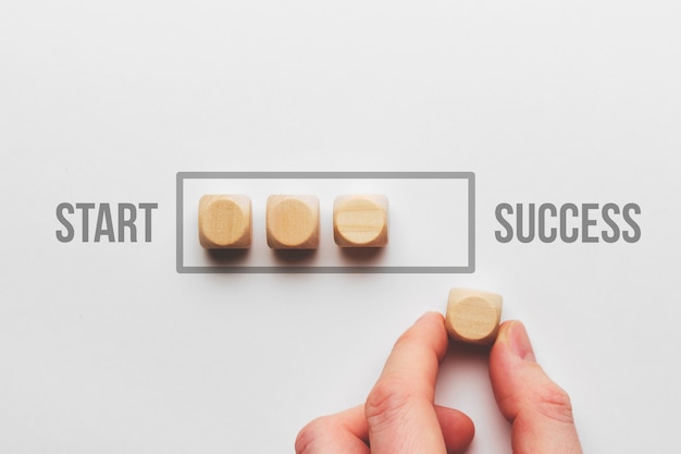 Success path concept with wooden cubes loading bar.