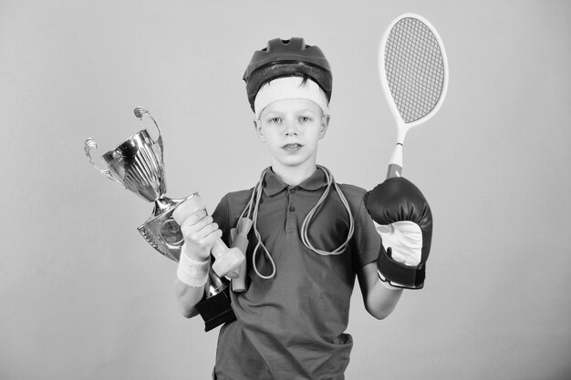 Success in sport Proud of achieved success Succeed in everything Athlete successful boy sport equipment jump rope boxing glove tennis racket roller skate and golden goblet Success and award