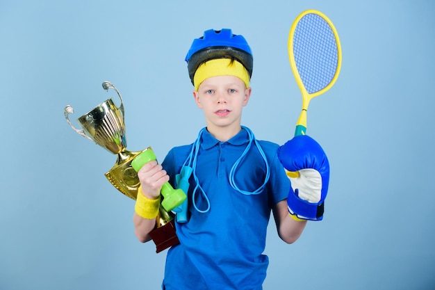 Success in sport proud of achieved success succeed in everything athlete successful boy sport equipment jump rope boxing glove tennis racket roller skate and golden goblet success and award