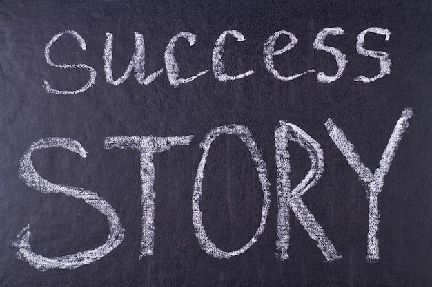 Success story phrase written with chalk on black board