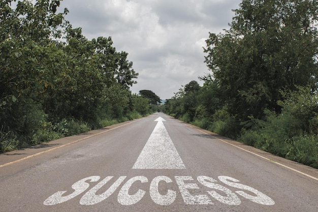 Success text on long country road on top of the mountain.