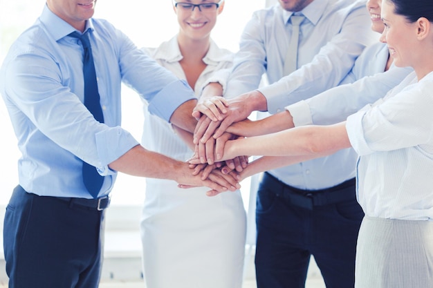 success and winning concept - happy business team celebrating victory in office