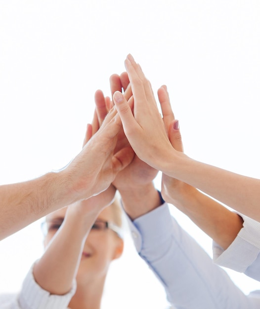 success and winning concept - happy business team giving high five in office