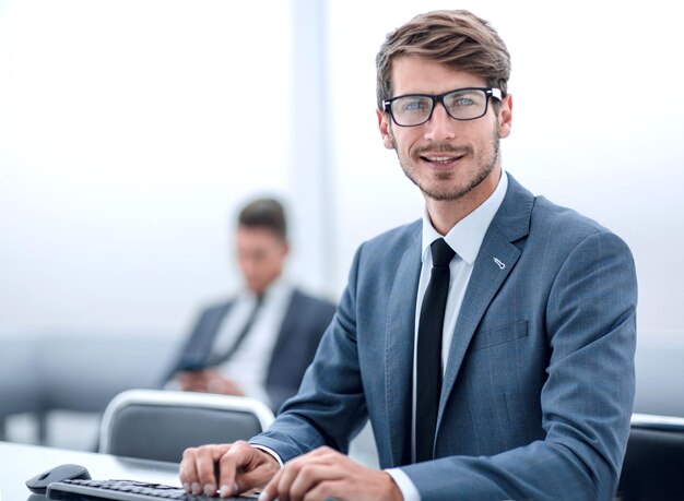 Successful adult man is looking at screen of modern gadget