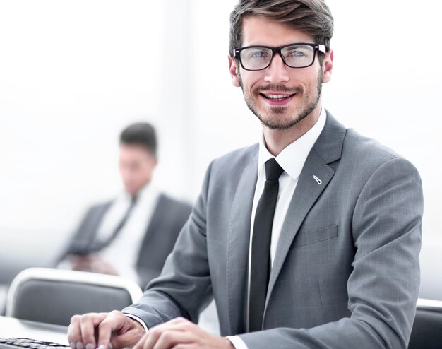 Successful adult man is looking at screen of modern gadget