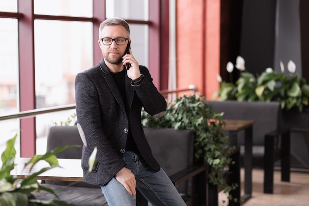 Successful adult man talking on the phone in a restaurant