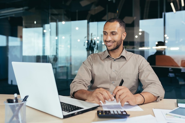 Successful african american businessman inside office doing paperwork man writing information worker