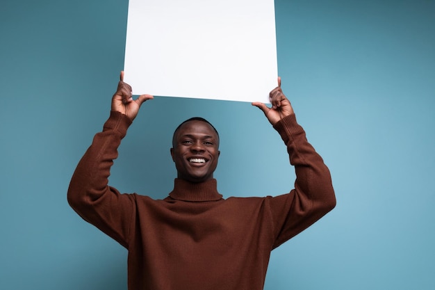 Successful african businessman demonstrates his projects using a white sheet of screen