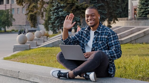 Successful african smiling man guy student male freelancer programmer designer in wireless