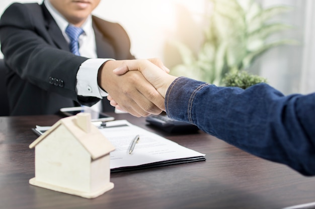 Successful agreement , estate,home buying contract concept, buyer shaking hand 