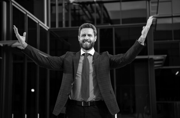 successful amazed businessman near office buildings business man excited portrait