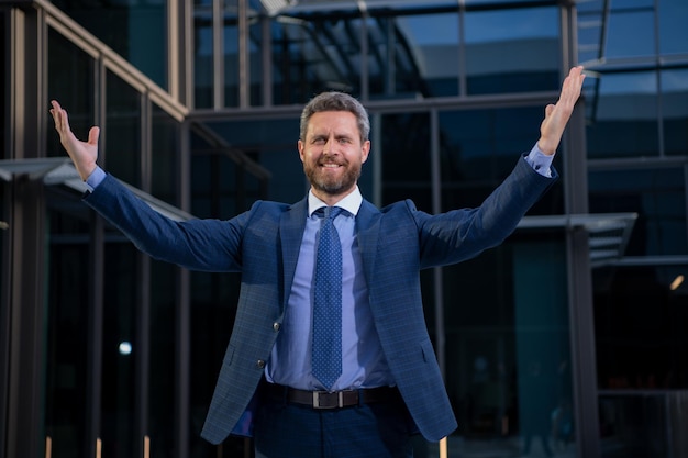 Successful amazed businessman near office buildings business man excited portrait