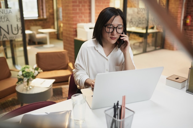 Successful Asian Businesswoman Working in Office