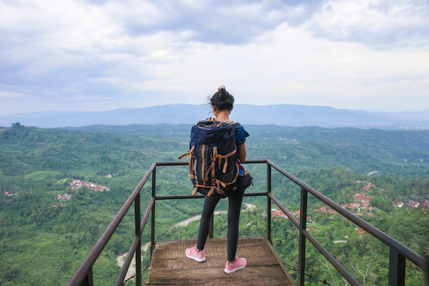 成功したアジアの女性ハイカーは山頂の景色をお楽しみください