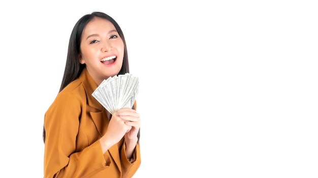 Successful beautiful Asian business young woman fill happy holding money US dollar bills in hand isolated on white background business success concept