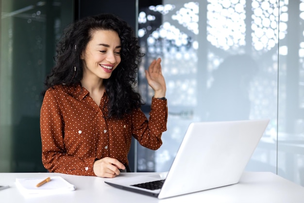 Successful and beautiful hispanic woman working inside modern office building businesswoman using