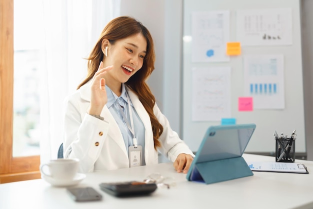 Successful business concept Businesswoman doing greeting gesture with colleague on video call