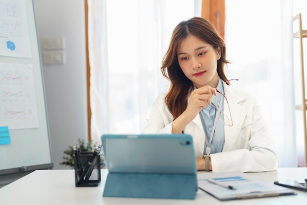 Successful business concept Businesswoman hold glasses and look data on tablet to analysis project