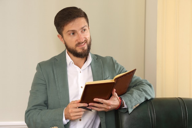 Successful business man in the office is studying the diary