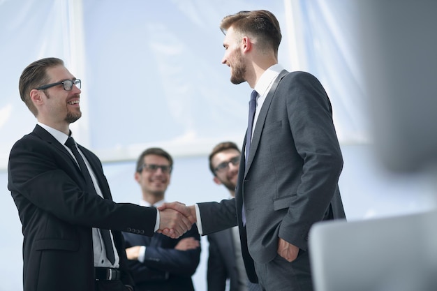 Successful business partners shaking hands business concept