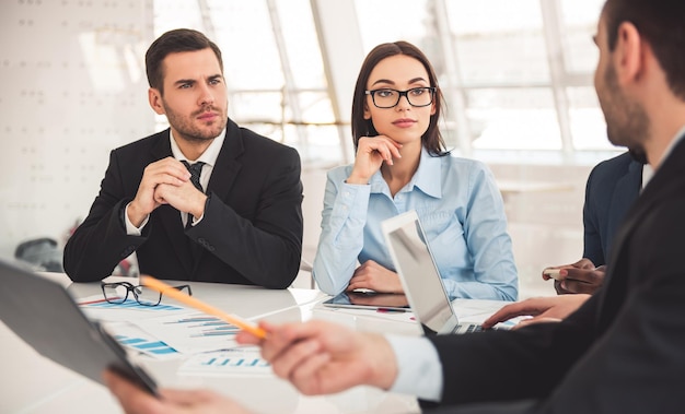 Successful business people are talking working with documents and smiling during the conference