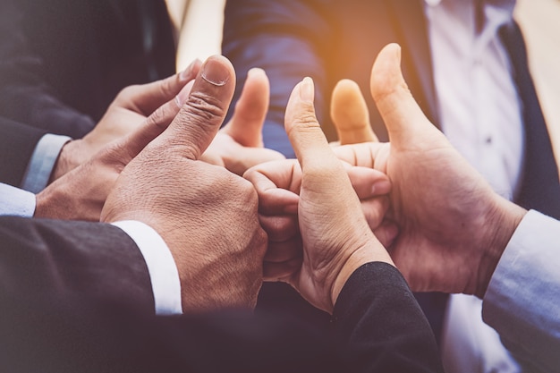 Successful business people with thumbs up and smiling, business team