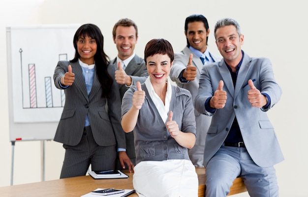 Successful business people with thumbs up 