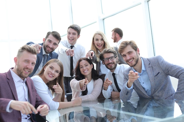 Successful business team is pointing at you